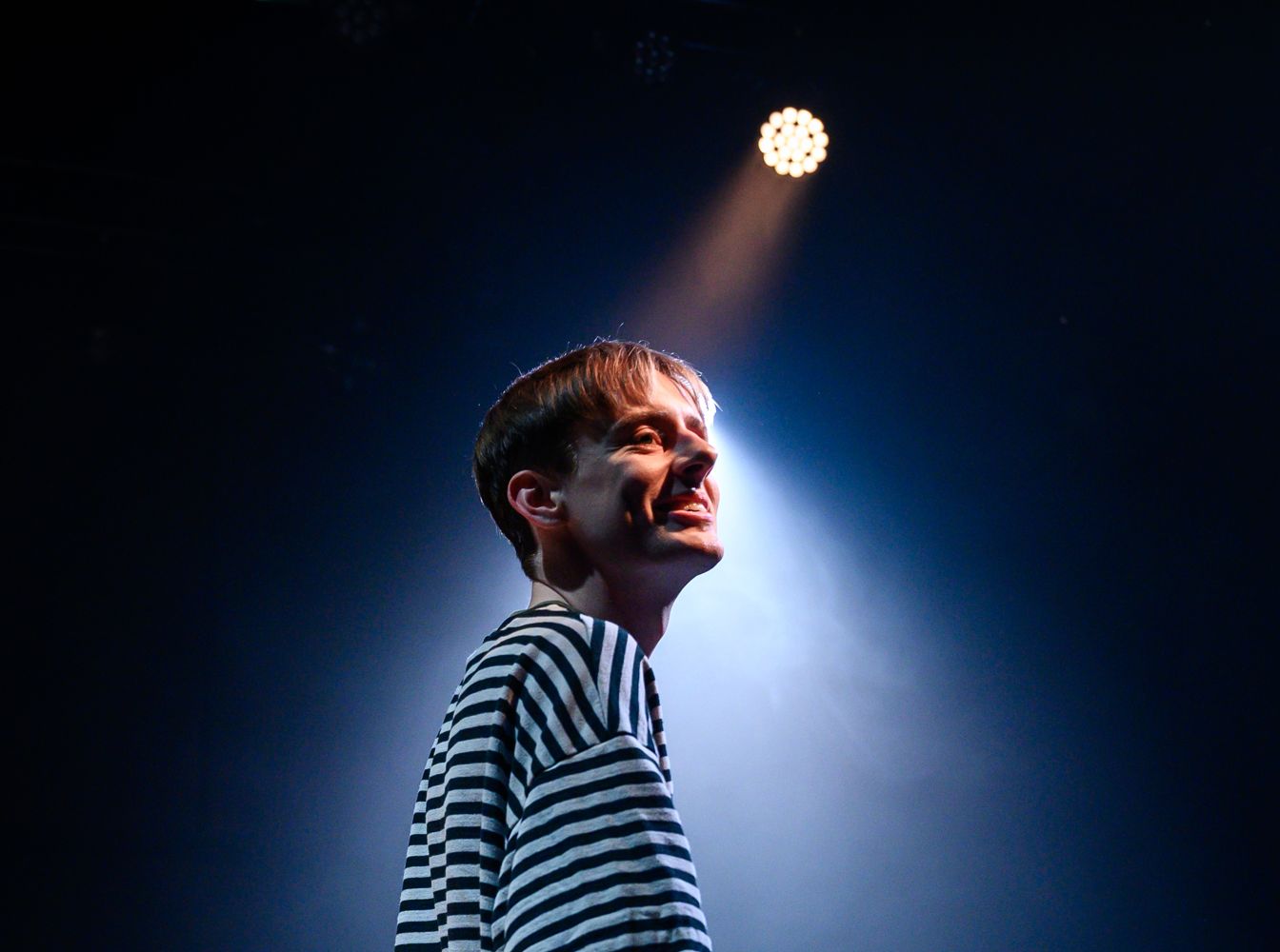 actor smiling in spotlight