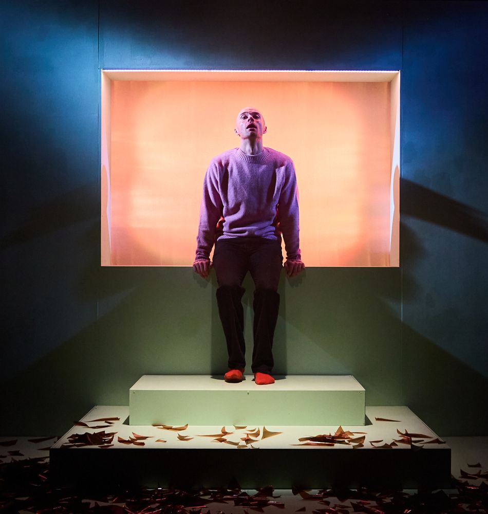 young actor inside square set eyes closed